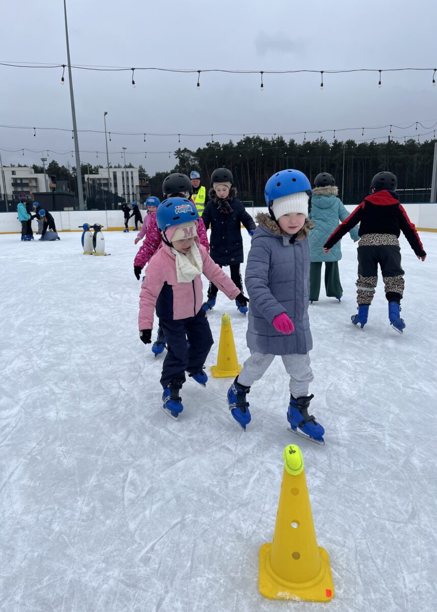 Wszystkie dzieci w kolejce jadą slalomem na łyżwach